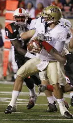 Tyler Palko is sacked by Louisville defender Elvis Dumervil during the first half.