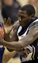 Carl Krauser tries to pass around DePaul's Lorenzo Thompson.