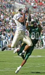 Sam Bryant, left, intercepts a pass intended for South Florida's Ean Randolph (80) during the second quarter. (AP Photo/Mike Carlson)