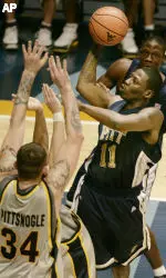 Carl Krauser shoots over West Virginia's Kevin Pittsnogle in the first half. (AP Photo/Keith Srakocic)