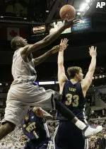 Georgetown's Brandon Bowman, left, drives and shoots against Pittsburgh's Aaron Gray (33) and Keith Benjamin (1) during the first half of their college basketball game Sunday, Feb. 5, 2006, in Washington. (AP Photo/Manuel Balce Ceneta)