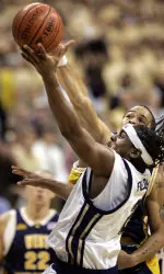 Levance Fields has a shot blocked as he is fouled by West Virginia's J.D. Collins in the first half.