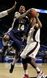 Guard Jania Sims goes up for a shot as she is fouled by Arizona's Rheya Neabors during the second half.
