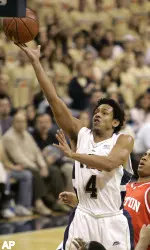 Ronald Ramon, who finished with 15 points, lays in two points in front of Boston University's Carlos Strong in the first half.