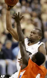Sam Young goes over Houston Baptist's Demetrus Judge on the way to the basket in the first half. (AP)