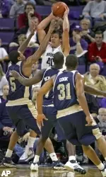 Washington's Jon Brockman tries to get out of the triple team defense of Tyrell Biggs, left, Keith Benjamin, Mike Cook (31) in the second half. (AP Photo/Kevin P. Casey)