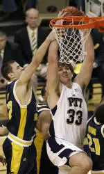 Pitt's Aaron Gray is fouled by West Virginia's Alex Ruoff as he tries to dunk in the first half. (AP Photo/Keith Srakocic)