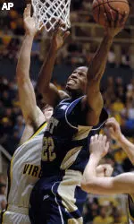 Pittsburgh's Antonio Graves drives through West Virginia's Joe Alexander, left, and Ted Talkington (not pictured) in the first half. (AP Photo/Jeff Gentner)