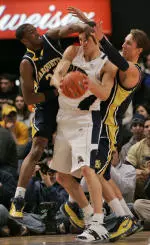 Levon Kendall, center, fight forthe ball against Marquette's Wesley Matthews (23) and Dan Fitzgerald. (AP Photo)