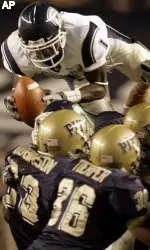 Connecticut's Darius Butler, top, tries to recover Pittsburgh's attempt on an onside kickoff as he dives over kickoff team players Michael Toerper (36) and Lowell Robinson (23) in the fourth quarter. Butler dropped the ball and Pitt recovered. (AP Photo/Keith Srakocic)