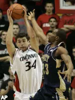 Cincinnati center Adam Hrycaniuk pulls a rebound away from Sam Young. (AP Photo/Al Behrman)