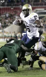 LeSean McCoy breaks through South Florida tacklers (AP Photo/Reinhold Matay)