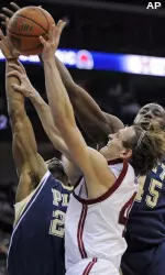Washington State guard Nikola Koprivica, center, puts up a shot as he is double-teamed by Pittsburgh's Sam Young, left, and DeJuan Blair, right, during the first half. (AP Photo/Bill Kostroun)