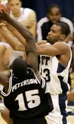 Pittsburgh' Sam Young, right, puts in two of his game-high 22 points over Providence's Jamine Peterson (15) (AP Photo)