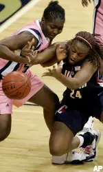 Sylvie Tafen battles with Connecticut's Charde Houston in first half. (AP Photo/Gene J. Puskar)