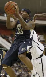 Pittsburgh's Nasir Robinson, left, gets around Duquesne's Damian Saunders. (AP)