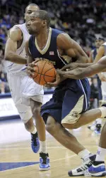 Sam Young drives to the basket as he cuts between Seton Hall's Eugene Harvey, right, and Robert Mitchell, left, during the second half. (AP Photo/Bill Kostroun)