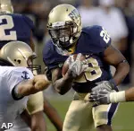 Pittsburgh running back Dion Lewis, right, runs past Navy linebacker Ross Pospisil for a touchdown. (AP)