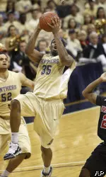 Nasir Robinson (35) goes up to score past Louisville's Preston Knowles, right, during the first half. (AP Photo/Keith Srakocic)