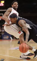 Gilbert Brown, foreground, drives past Maryland's Sean Mosley. (AP)