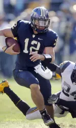 Quarterback Tino Sunseri (12) gets away from West Virginia cornerback Eain Smith (24) as he scrambles for a first down during the first quarter. (AP Photo/Keith Srakocic)