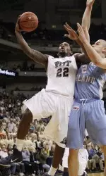 (AP) - Pittsburgh's Brad Wannamaker, left, goes around Rhode Island's Ben Eaves to score in the first half.