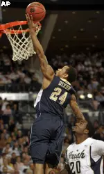 Jermaine Dixon, left, lays the ball in the basket as Notre Dame guard Jonathan Peoples defends in the first half.