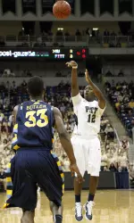 Ashton Gibbs (12) hits a three-point shot over Marquette's Jimmy Butler (33) in the first half. (AP Photo/Keith Srakocic)
