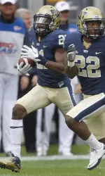 (AP) Pittsburgh kick returner Buddy Jackson (21) follows the block of Antwuan Reed (22) as he runs a kickoff back 97-yards for a touchdown in the first quarter.