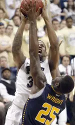 Pittsburgh's Nasir Robinson, left, shoots over La Salle's Jerrell Wright (25) in the first half.