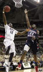 Pittsburgh's Ashton Gibbs (12) goes in for a layup in front of Robert Morris' Lucky Jones (22).