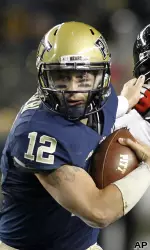 Pittsburgh quarterback Tino Sunseri (12) evades Cincinnati defensive lineman John Hughes.