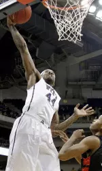Pittsburgh's J.J. Moore (44) goes over St. Francis (Pa.)'s Ollie Jackson (22) for a dunk in the first half.