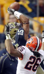 Pittsburgh wide receiver Devin Street (15) makes a leaping catch for a first down as Syracuse cornerback Kevyn Scott (26) defends during the second quarter. (AP Images)