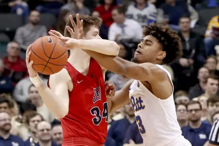 Duquesne's Austin Rotroff (34) looks to pass as Pittsburgh's Malik Ellison (3) defends during the first half of an NCAA college basketball game, Friday, Nov. 30, 2018, in Pittsburgh. (AP Photo/Keith Srakocic)