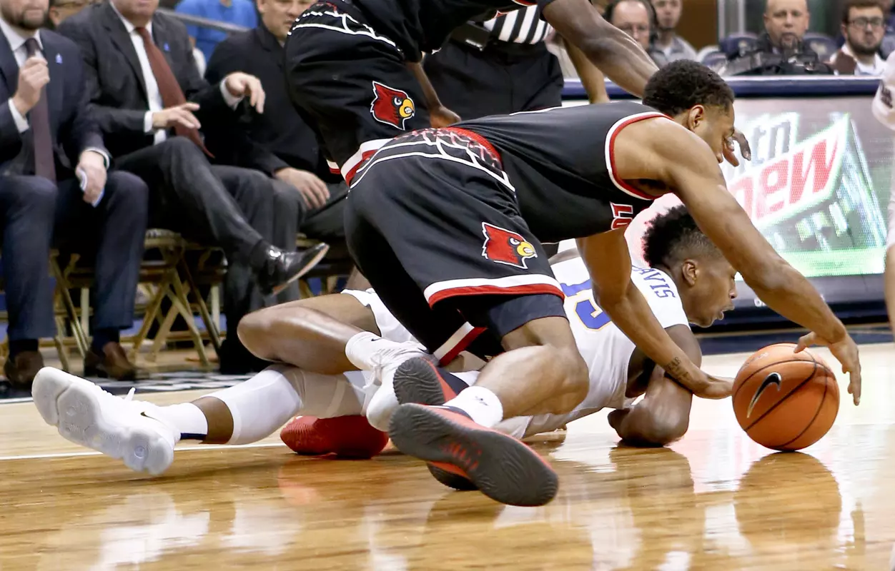 Louisville's V.J. King, top, and Pittsburgh's Kene Chukwuka (15) scramble for the ball during the first half of an NCAA college basketball game, Sunday, Feb. 11, 2018, in Pittsburgh. (AP Photo/Keith Srakocic)