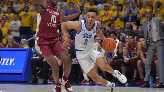 Trey McGowens dribbling past a defender against Florida State.