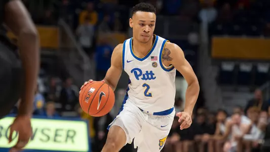 Trey McGowens dribbling.