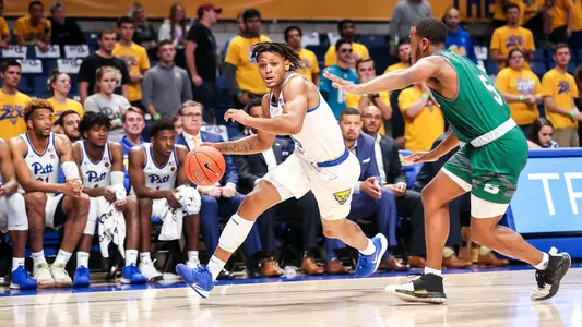 Au'diese Toney dribbling passed a defender against Slippery Rock.