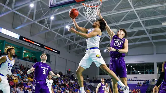 Justin Champagnie attempting a layup against Northwestern.