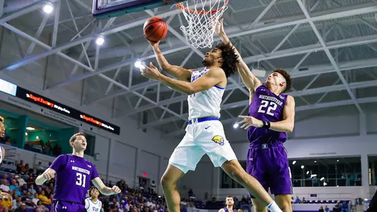 Justin Champagnie attempting a layup against Northwestern.