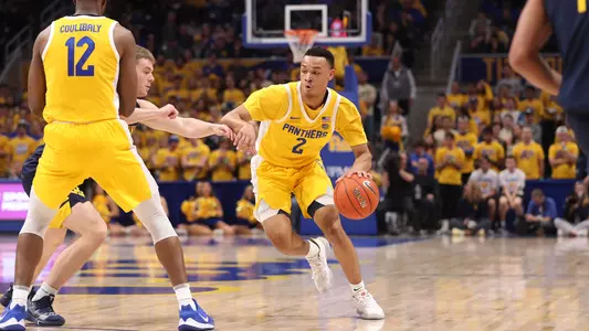 Trey McGowens dribbling around a pick against West Virginia.