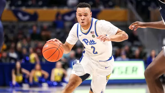 Trey McGowens dribbling.