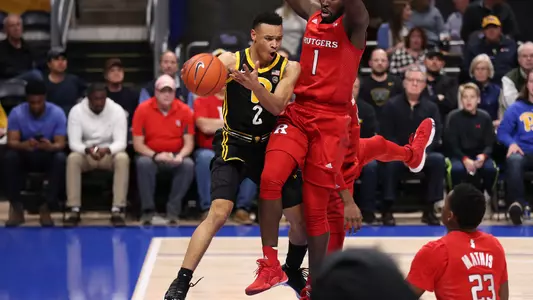 Trey McGowens passing around a defender against Rutgers.