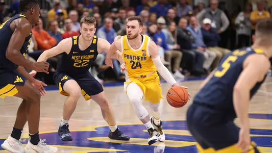Ryan Murphy dribbling past defenders against West Virginia.