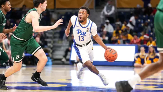 KJ Marshall dribbling against a Binghamton defender.