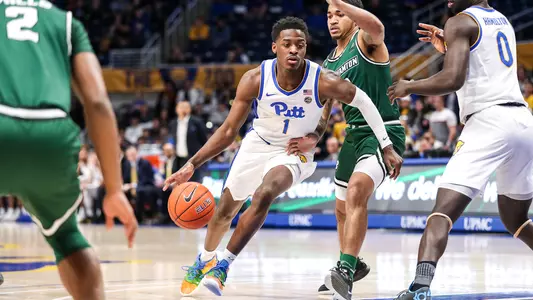 Xavier Johnson dribbling past a Binghamton defender.