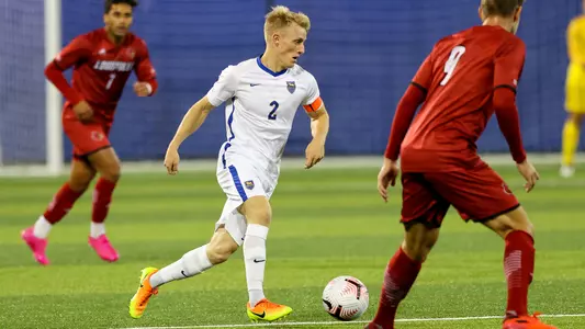 Jasper Loeffelsend dribbling against Louisville.