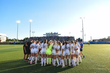 Pitt women's soccer team in huddle at Ambrose Urbanic Field