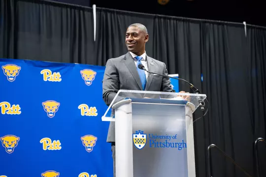 Allen Greene speaks at a podium